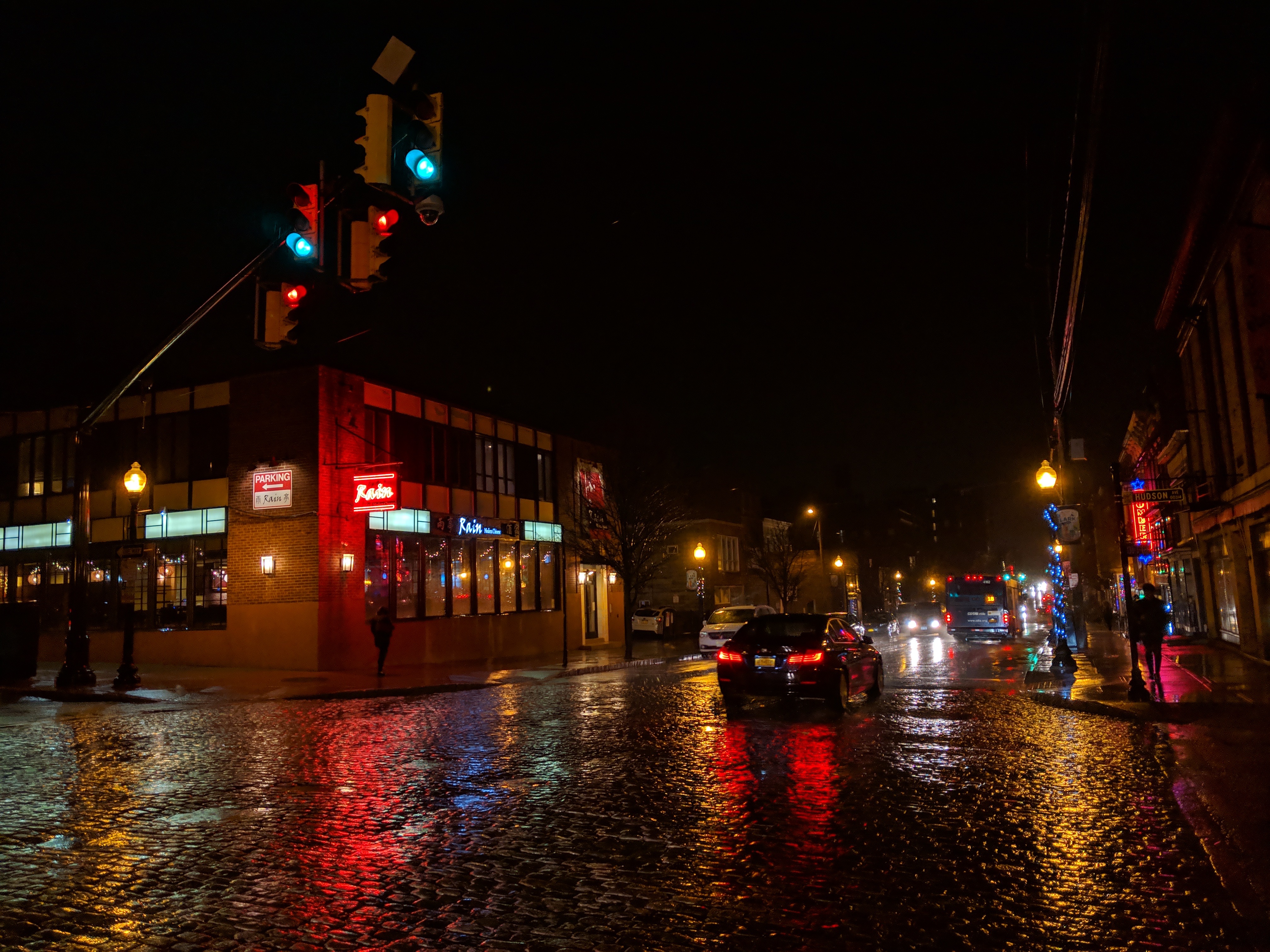 Rainy night street scene with neon reflections in Albany, NY